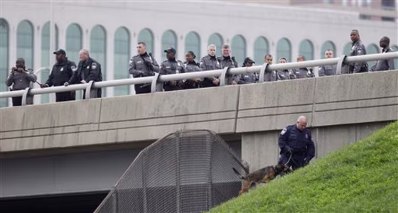Law enforcement officers search for evidence along the I-395 expressway adjacent to the Pentagon, on&nbsp;Oct. 19. Authorities now say that shots fired Oct. 18 at the National Museum of the Marine Corps in Triangle, Virginia, and on Oct. 19 the Pentagon in Arlington, Virginia,&nbsp;have been&nbsp;linked to the same firearm.
